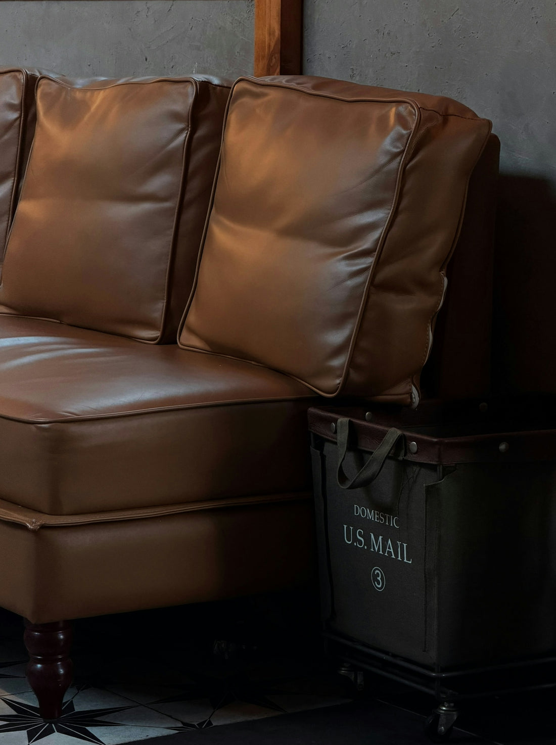 Brown leather sofa with u.s. mail storage bin