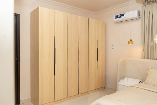 Modern light wood wardrobe in a clean bedroom interior