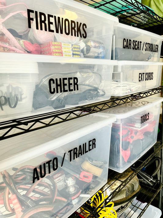Clear plastic storage bins with black labels on a metal wire shelving unit